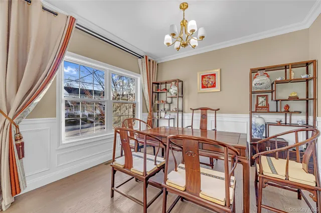 a view of a dining room with furniture and chandelier