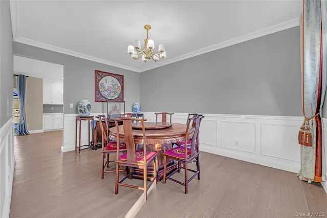 a view of a dining room with furniture and chandelier