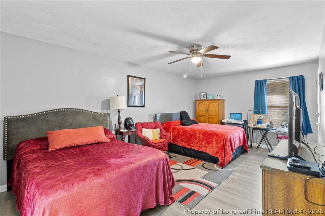 1912 Havilah Road Fayetteville, NC 28303 - Photo 11 of 14 a bedroom with beds and a chandelier