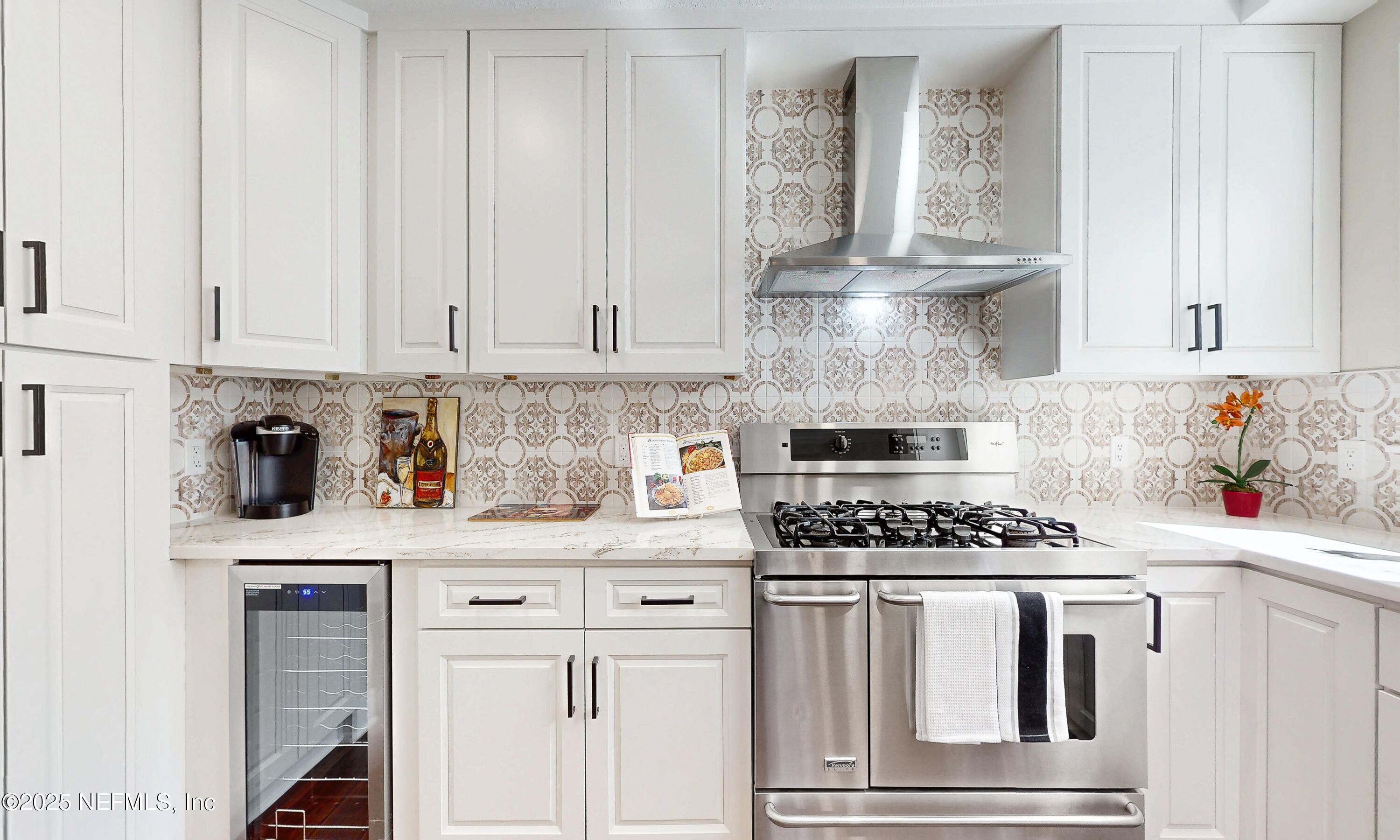 1153 Monticello Road Jacksonville, FL 32207 - Photo 11 of 37 a kitchen with white cabinets and appliances