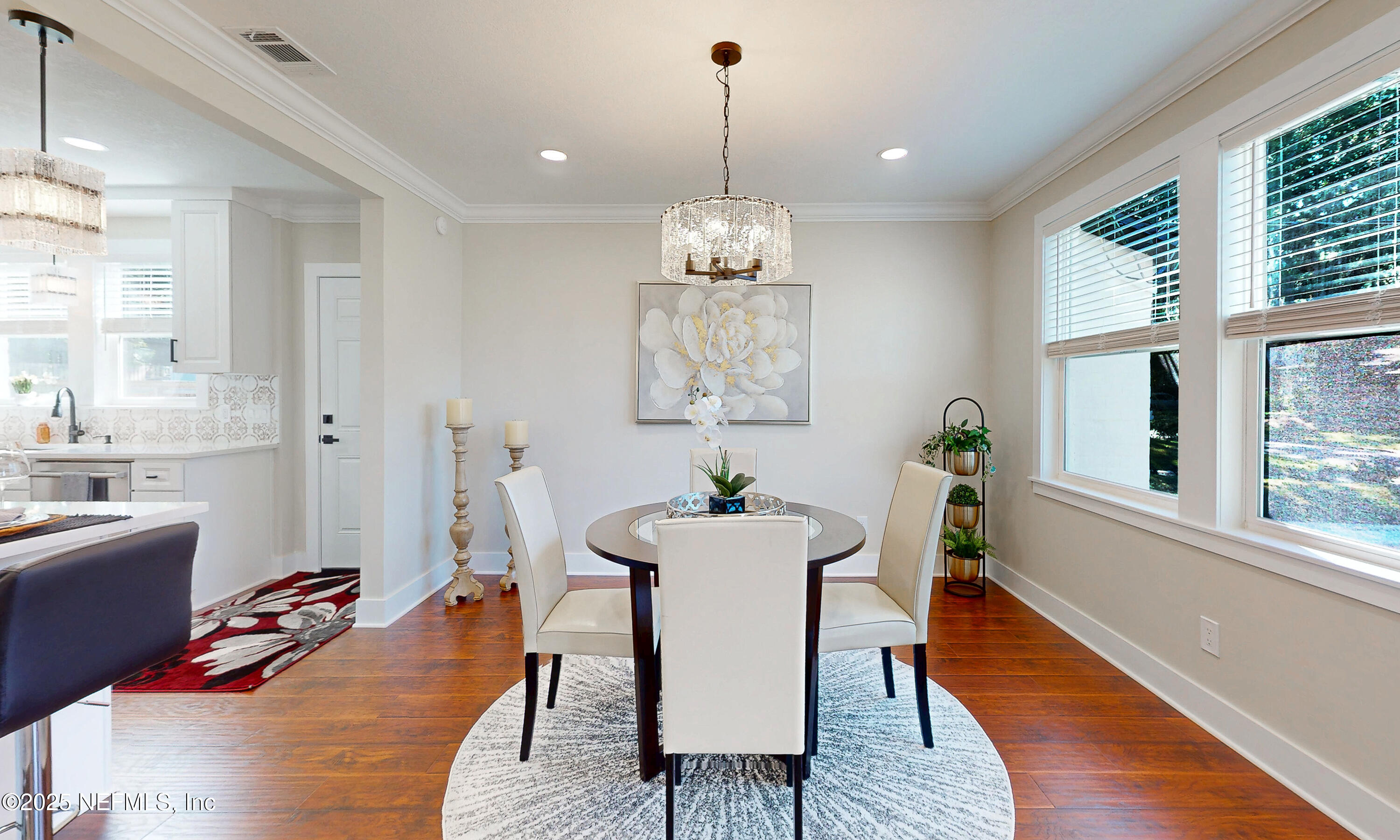 1153 Monticello Road Jacksonville, FL 32207 - Photo 14 of 37 a dining room with furniture a chandelier and wooden floor