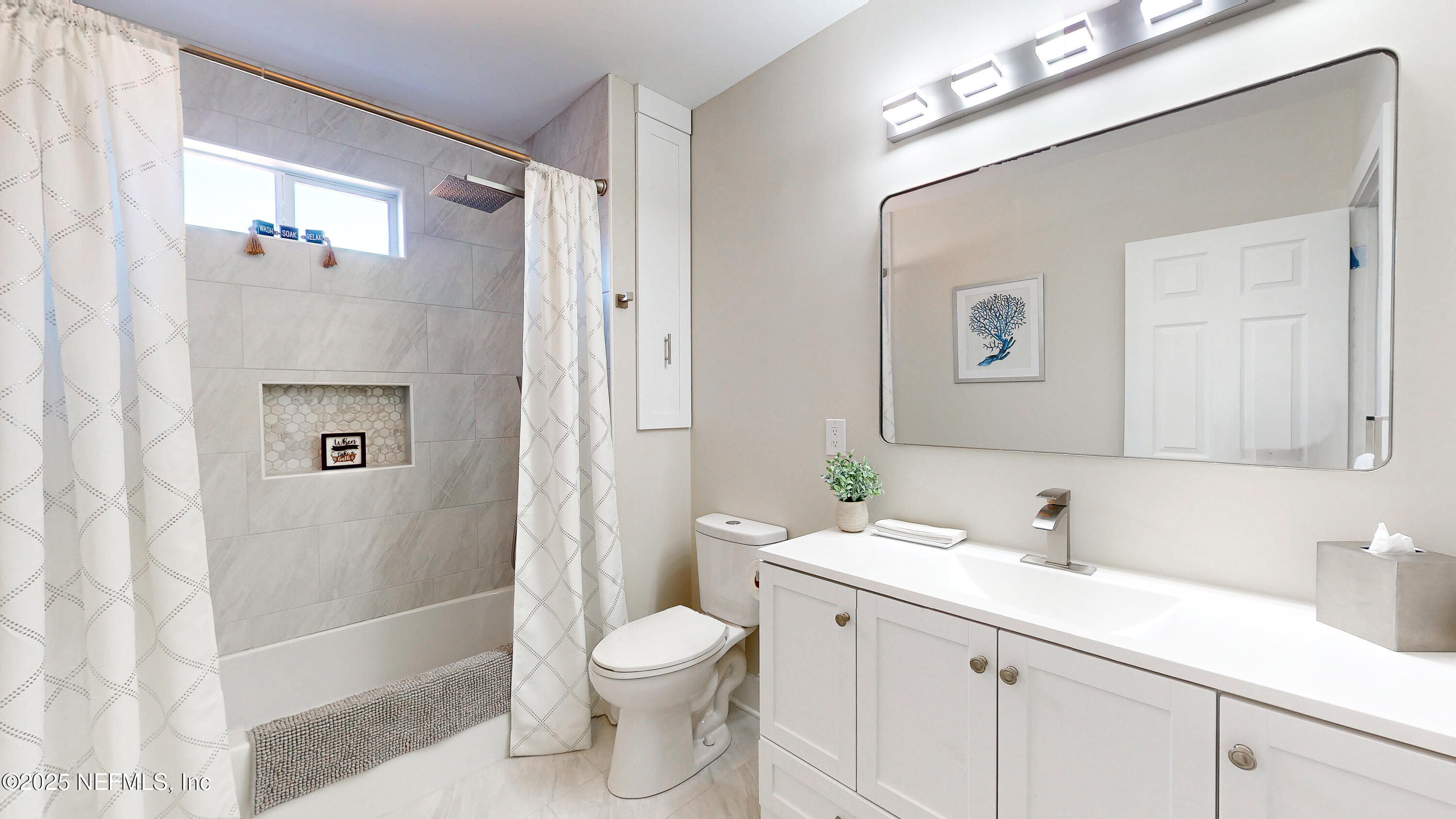 1153 Monticello Road Jacksonville, FL 32207 - Photo 22 of 37 a bathroom with a sink a toilet and shower