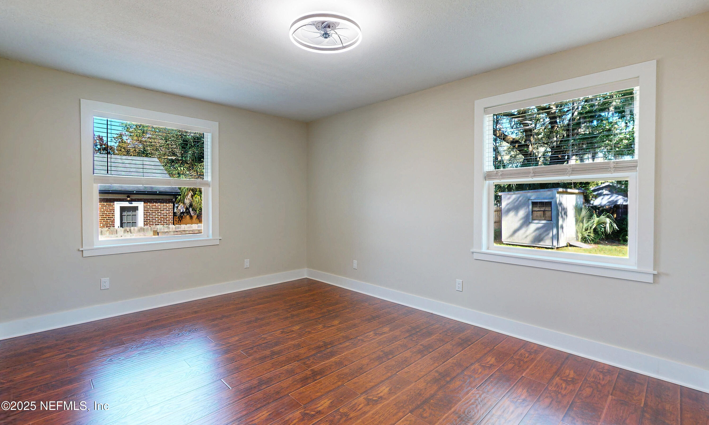 1153 Monticello Road Jacksonville, FL 32207 - Photo 23 of 37 a view of an empty room with wooden floor and a window