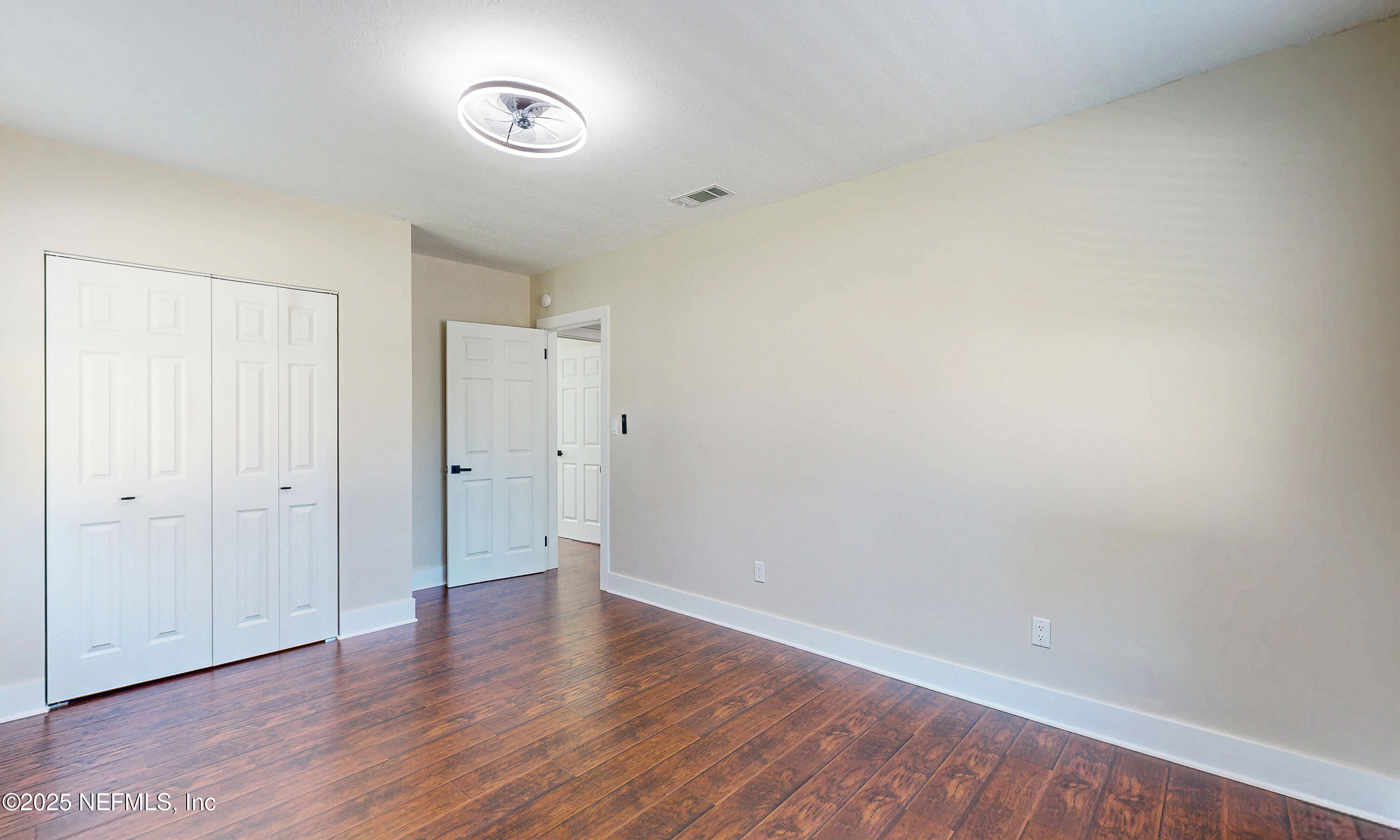 1153 Monticello Road Jacksonville, FL 32207 - Photo 24 of 37 a view of an empty room with wooden floor and a window