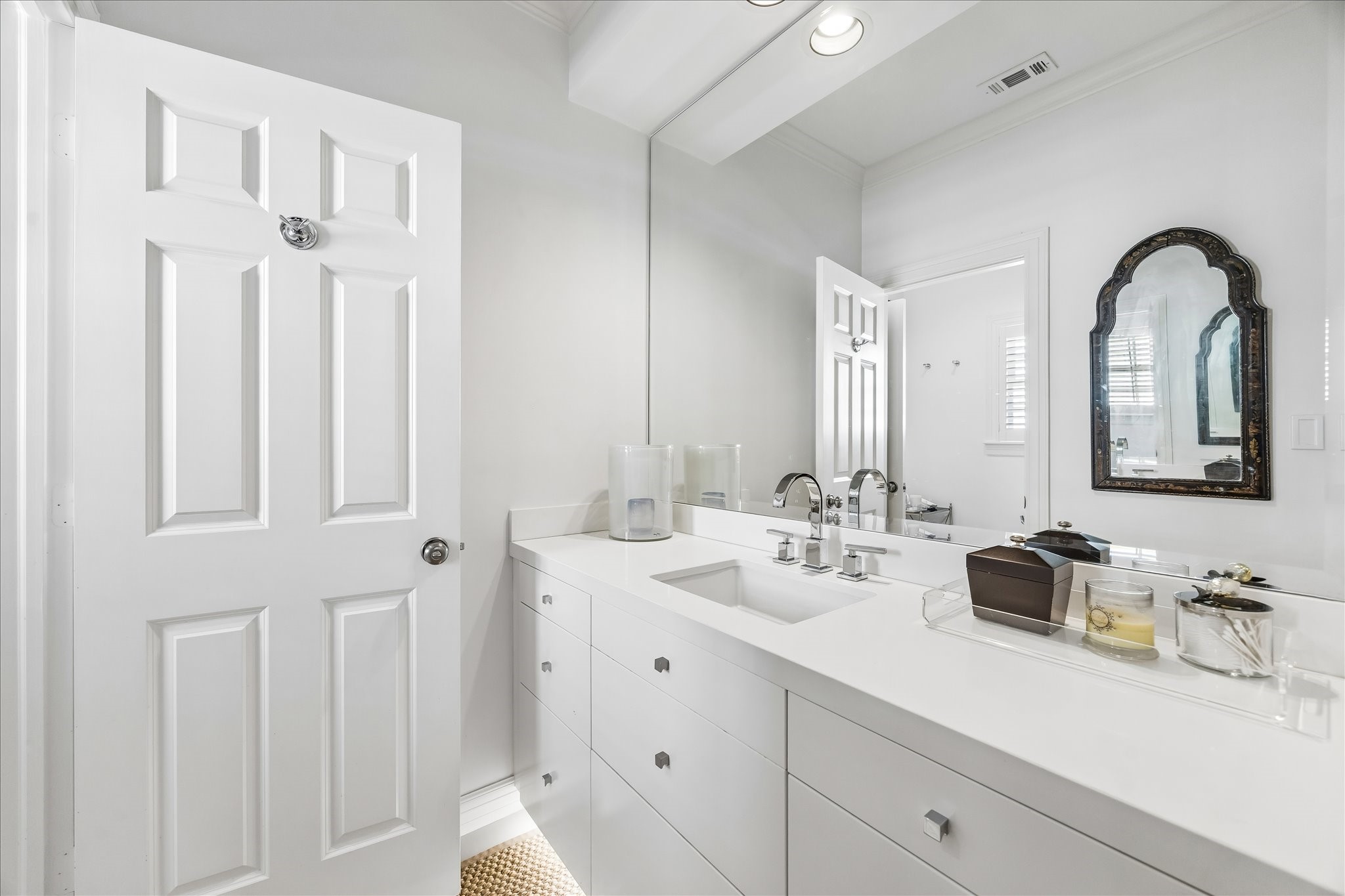 2627 Sutton Court Houston, TX 77027 - Photo 22 of 34 The Jack and Jill bathroom was updated in 2017* with quartz countertops, separate vanities, under-cabinet floor lighting and a large closet with built-ins. The space exudes elegance. *Per seller