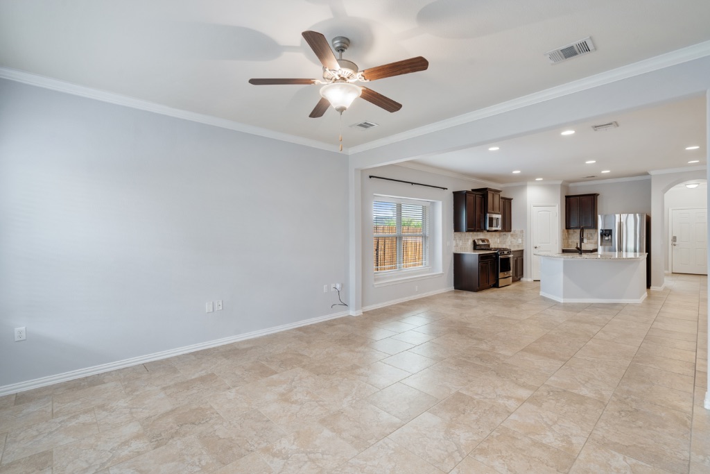 5704 Arbor Hill Lane Austin, TX 78747 - Photo 11 of 32 a view of an empty room with a kitchen