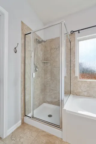 a bathroom with a shower and a bathtub