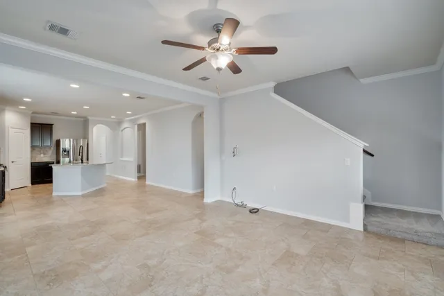 a view of an empty room with a ceiling fan