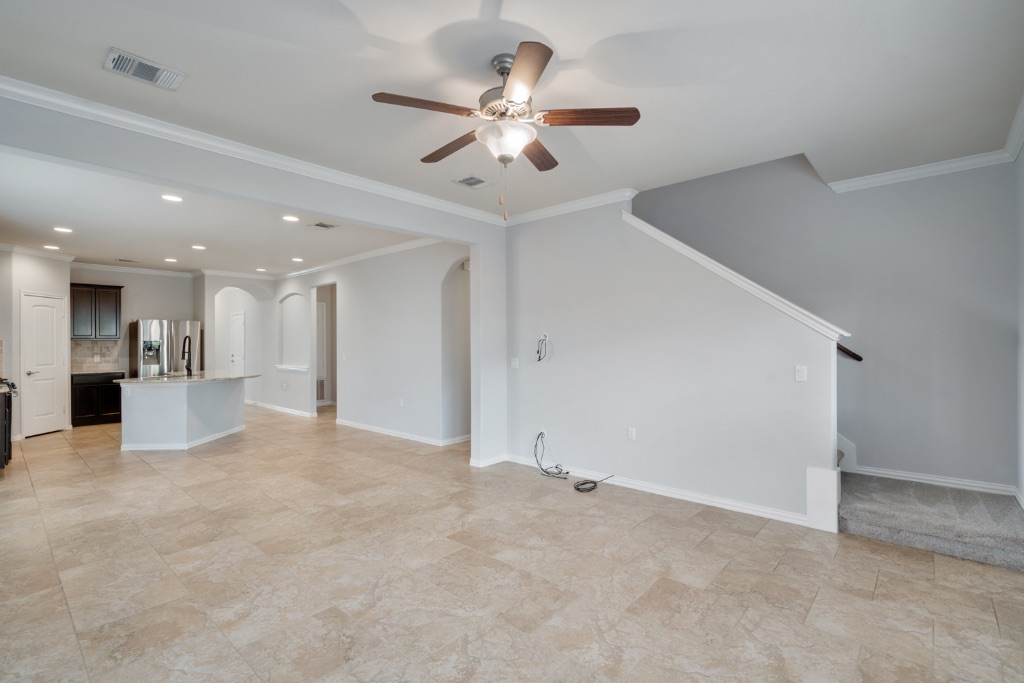5704 Arbor Hill Lane Austin, TX 78747 - Photo 10 of 32 a view of an empty room with a ceiling fan