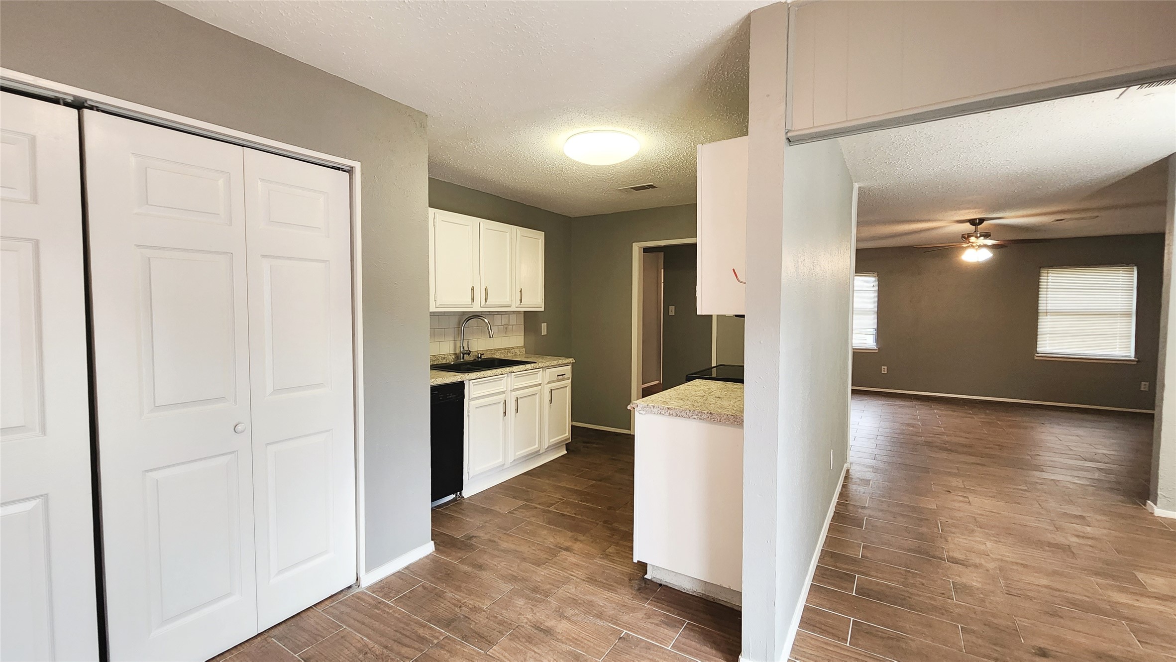 24119 Anchor Ranch Drive Hockley, TX 77447 - Photo 2 of 11 a kitchen with a refrigerator a sink and cabinets
