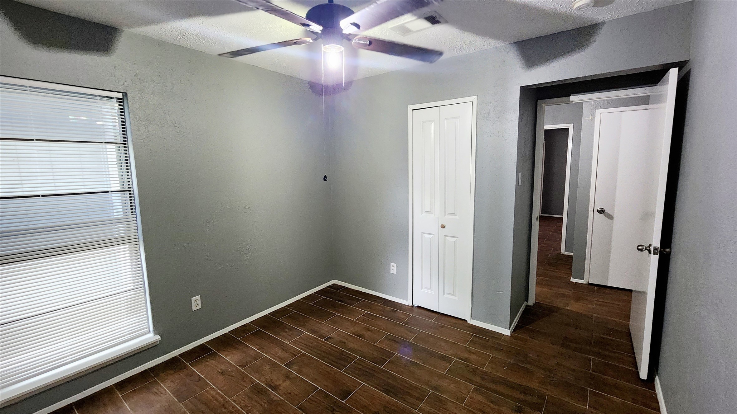 24119 Anchor Ranch Drive Hockley, TX 77447 - Photo 4 of 11 a view of an empty room with wooden floor and a window