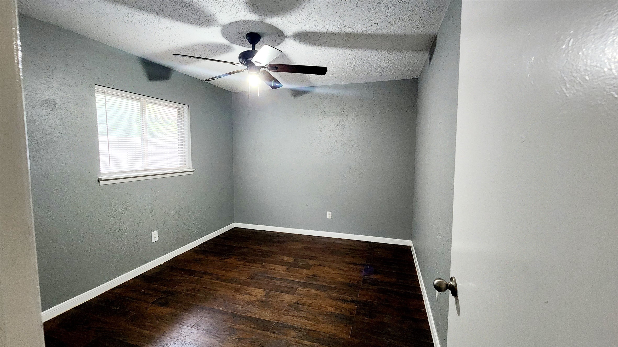 24119 Anchor Ranch Drive Hockley, TX 77447 - Photo 6 of 11 an empty room with wooden floor fan and windows