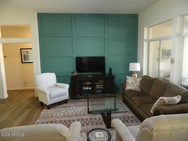 a living room with furniture and a flat screen tv