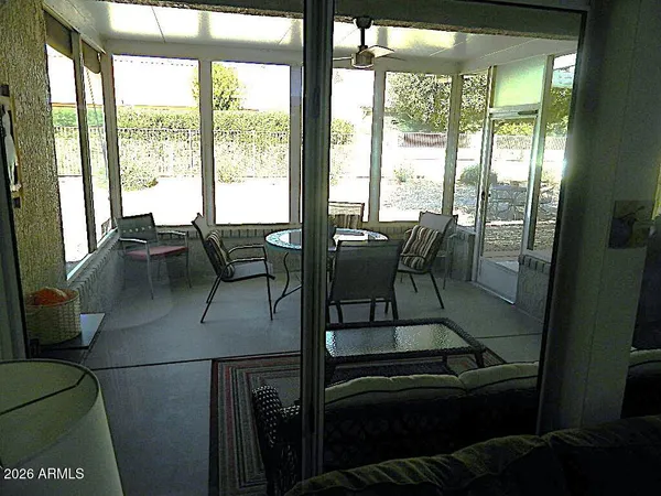 a view of a dining room with furniture large windows and wooden floor