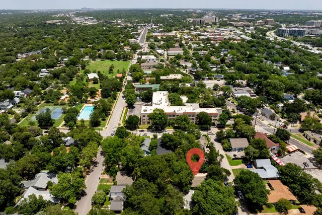 an aerial view of residential houses with outdoor space