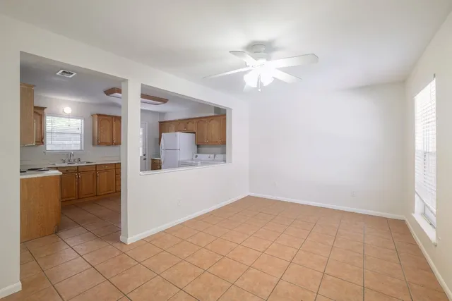 a utility room with cabinets washer and dryer