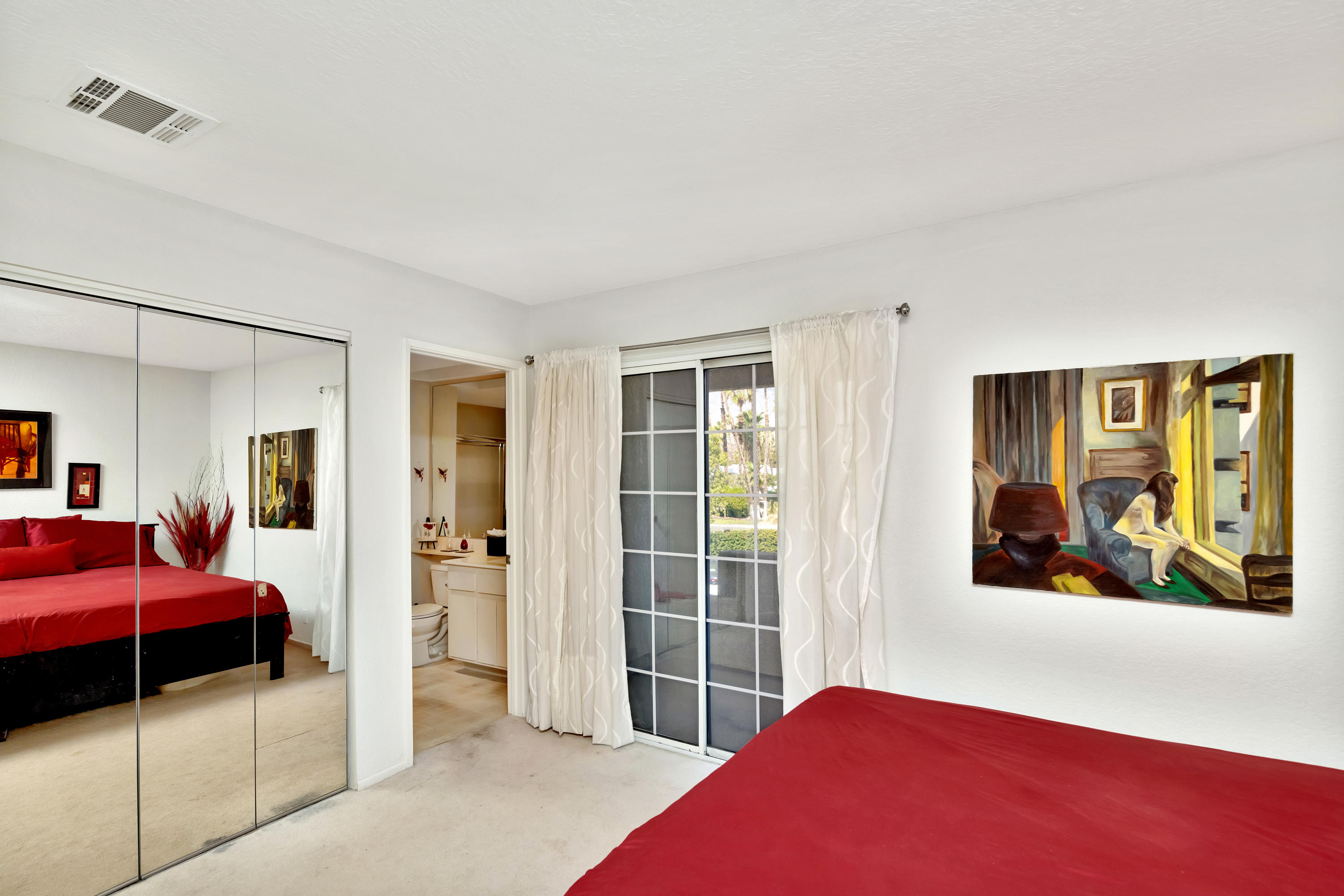 2700 Lawrence Crossley Road, Unit 9 Palm Springs, CA 92264 - Photo 13 of 27 a bedroom with a bed and a view of bathroom