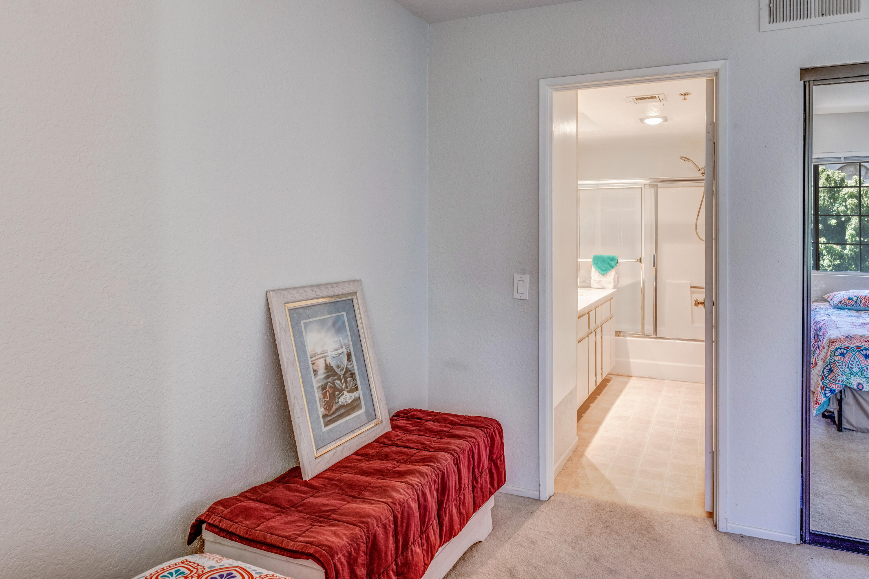 2700 Lawrence Crossley Road, Unit 9 Palm Springs, CA 92264 - Photo 16 of 27 a bedroom with a bed and a painting on the wall