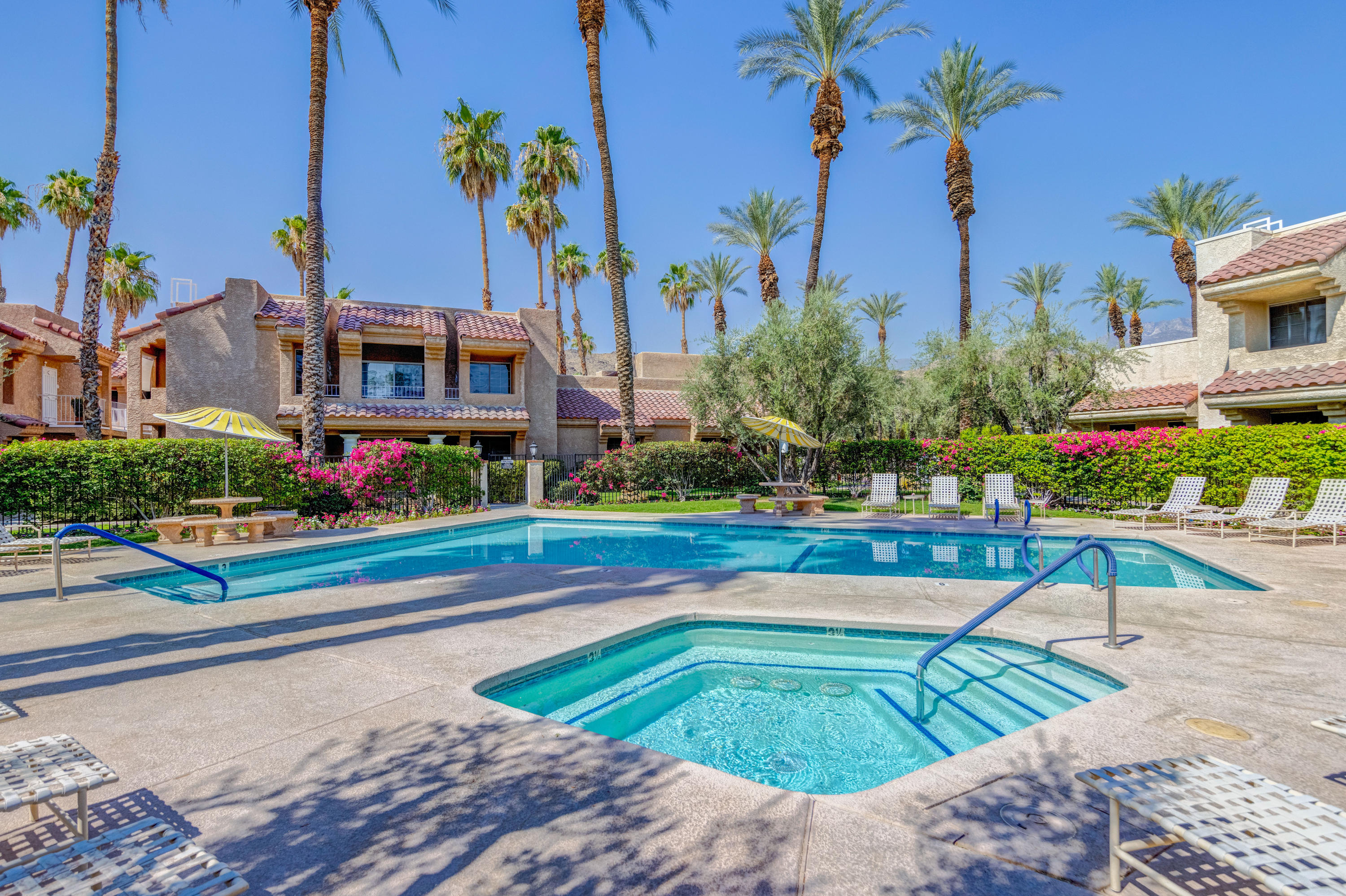 2700 Lawrence Crossley Road, Unit 9 Palm Springs, CA 92264 - Photo 23 of 27 a view of a swimming pool with a lounge chairs