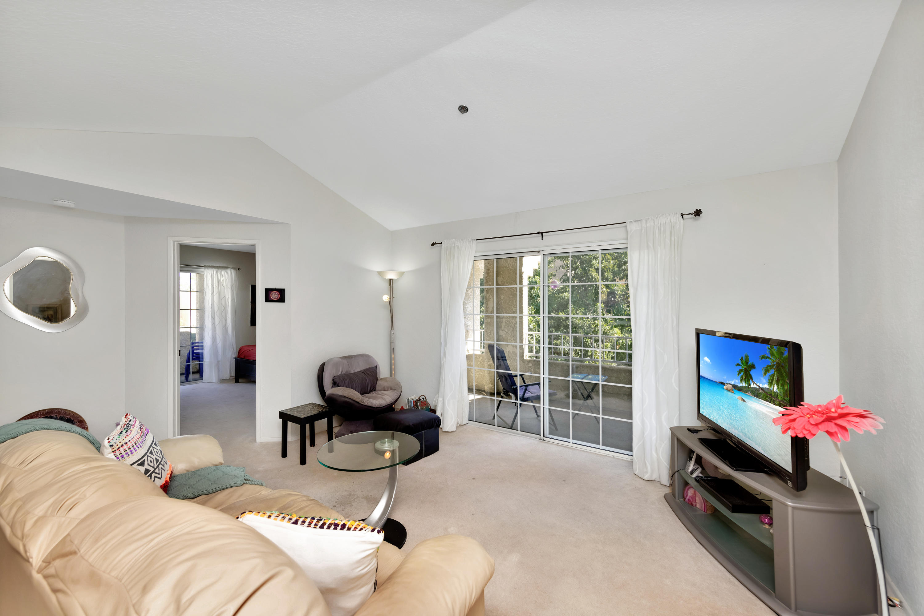 2700 Lawrence Crossley Road, Unit 9 Palm Springs, CA 92264 - Photo 4 of 27 a living room with furniture a flat screen tv and a window