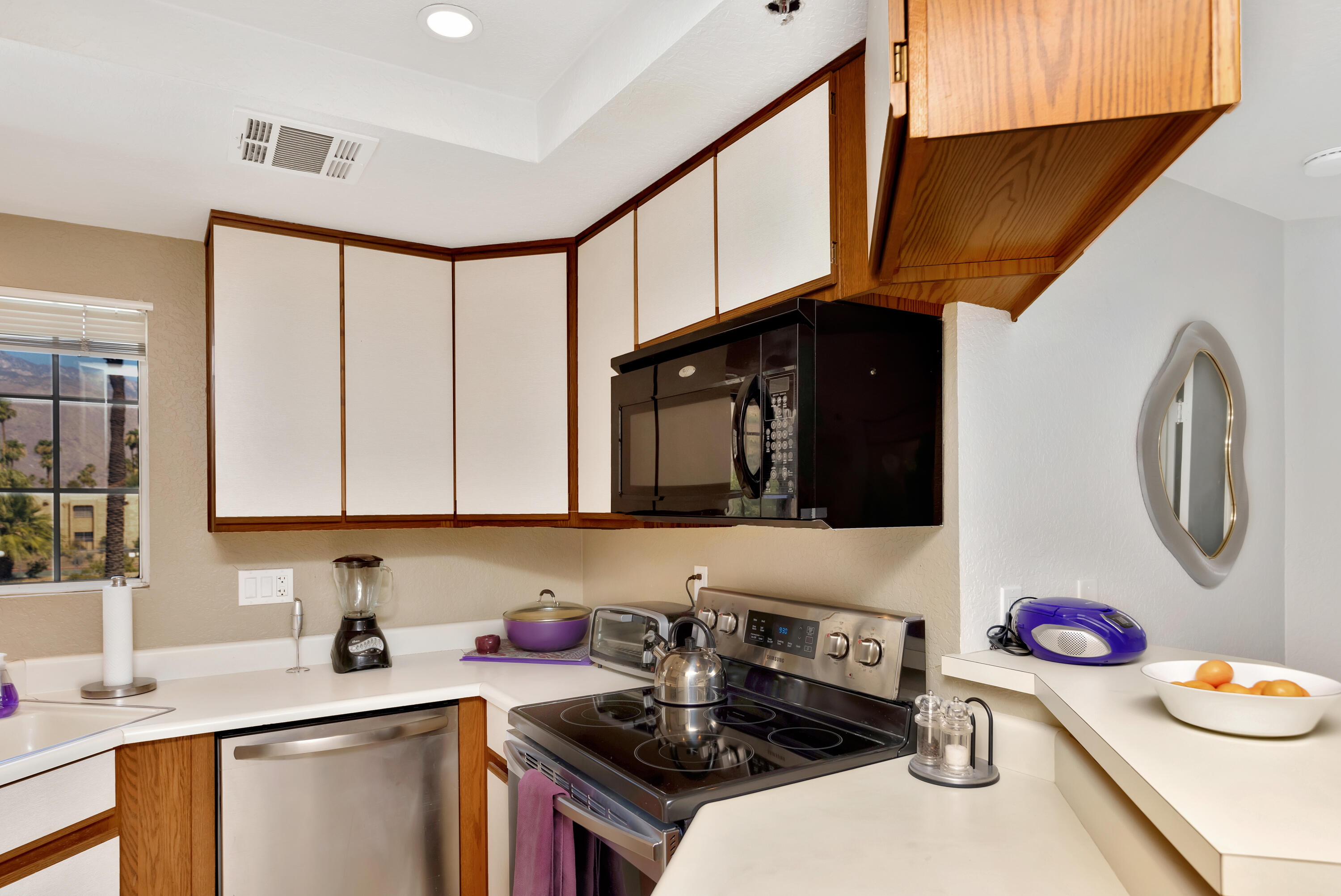 2700 Lawrence Crossley Road, Unit 9 Palm Springs, CA 92264 - Photo 9 of 27 a kitchen with a stove a sink and a microwave