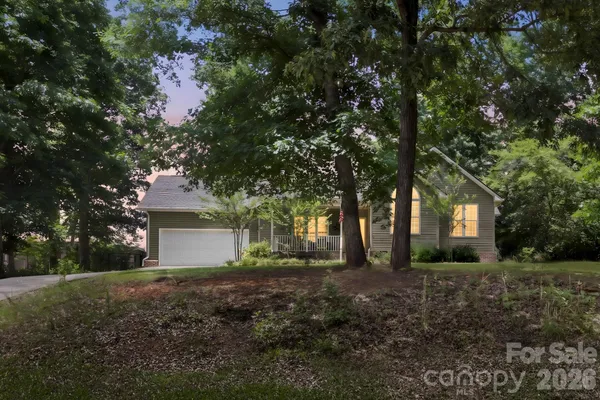 a front view of house with yard and trees