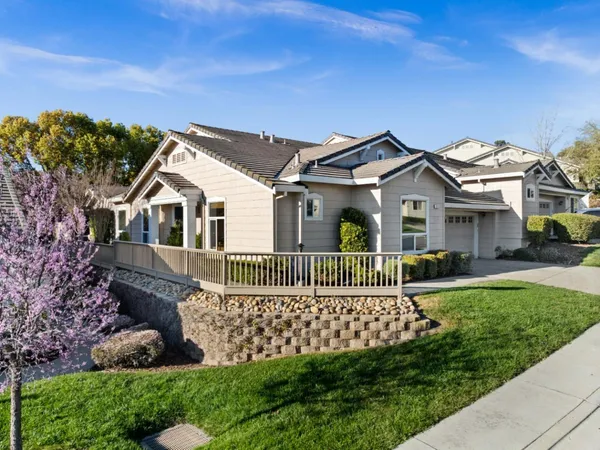 a front view of a house with a garden