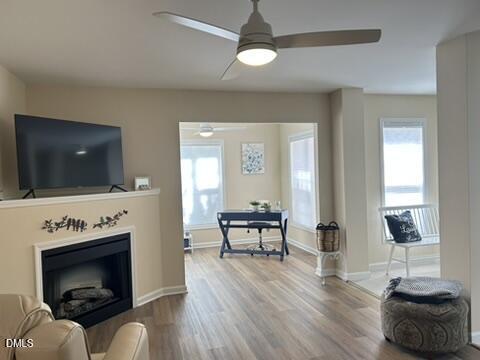 2510 Friedland Place, Unit 102 Raleigh, NC 27617 - Photo 16 of 42 a living room with furniture a flat screen tv and a fireplace