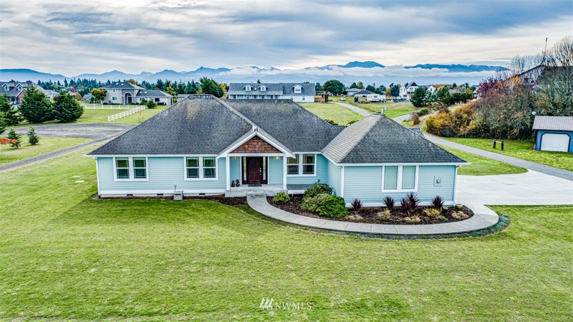a aerial view of a house with swimming pool garden and lake view