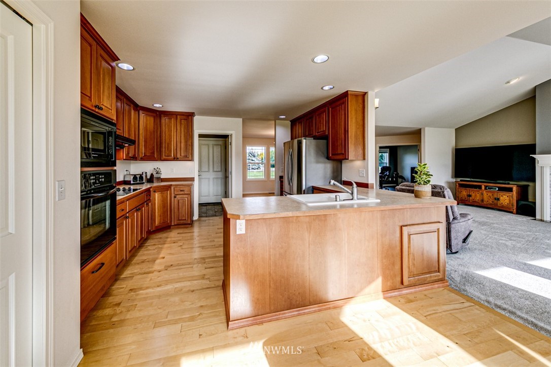 72 Buckhorn Road Sequim, WA 98382 - Photo 14 of 40 a kitchen with stainless steel appliances granite countertop a stove a sink and a microwave