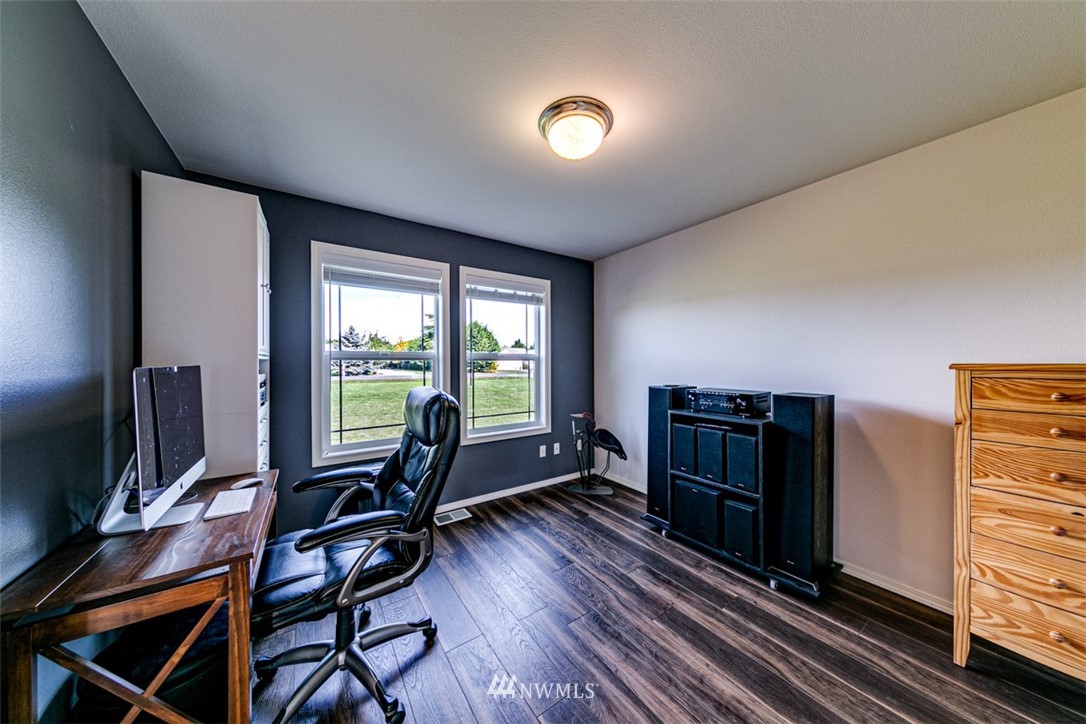 72 Buckhorn Road Sequim, WA 98382 - Photo 23 of 40 a living room with furniture a flat screen tv and floor to ceiling window