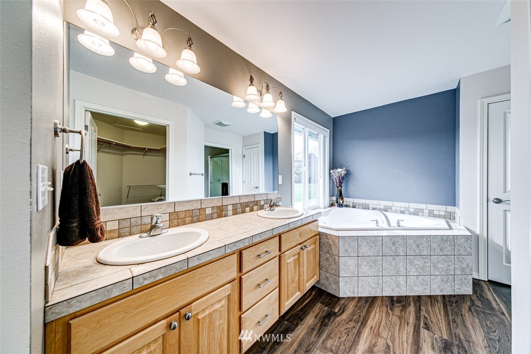 72 Buckhorn Road Sequim, WA 98382 - Photo 29 of 40 a bathroom with a double vanity sink mirror and bathtub