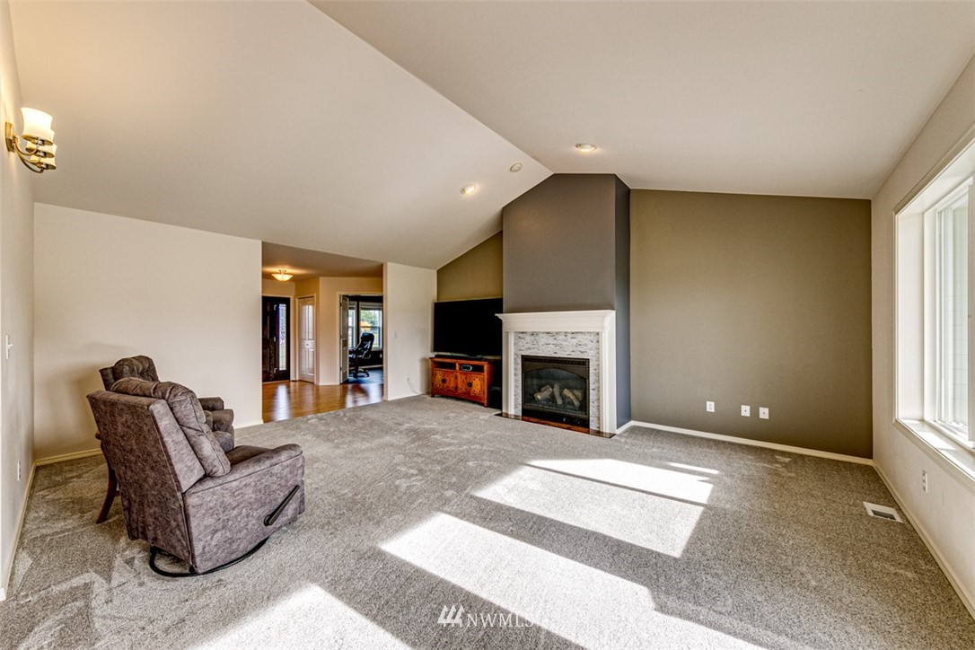 72 Buckhorn Road Sequim, WA 98382 - Photo 9 of 40 a living room with furniture a fireplace and a large window