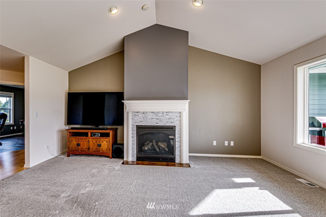 72 Buckhorn Road Sequim, WA 98382 - Photo 10 of 40 a living room with furniture a flat screen tv and a fireplace