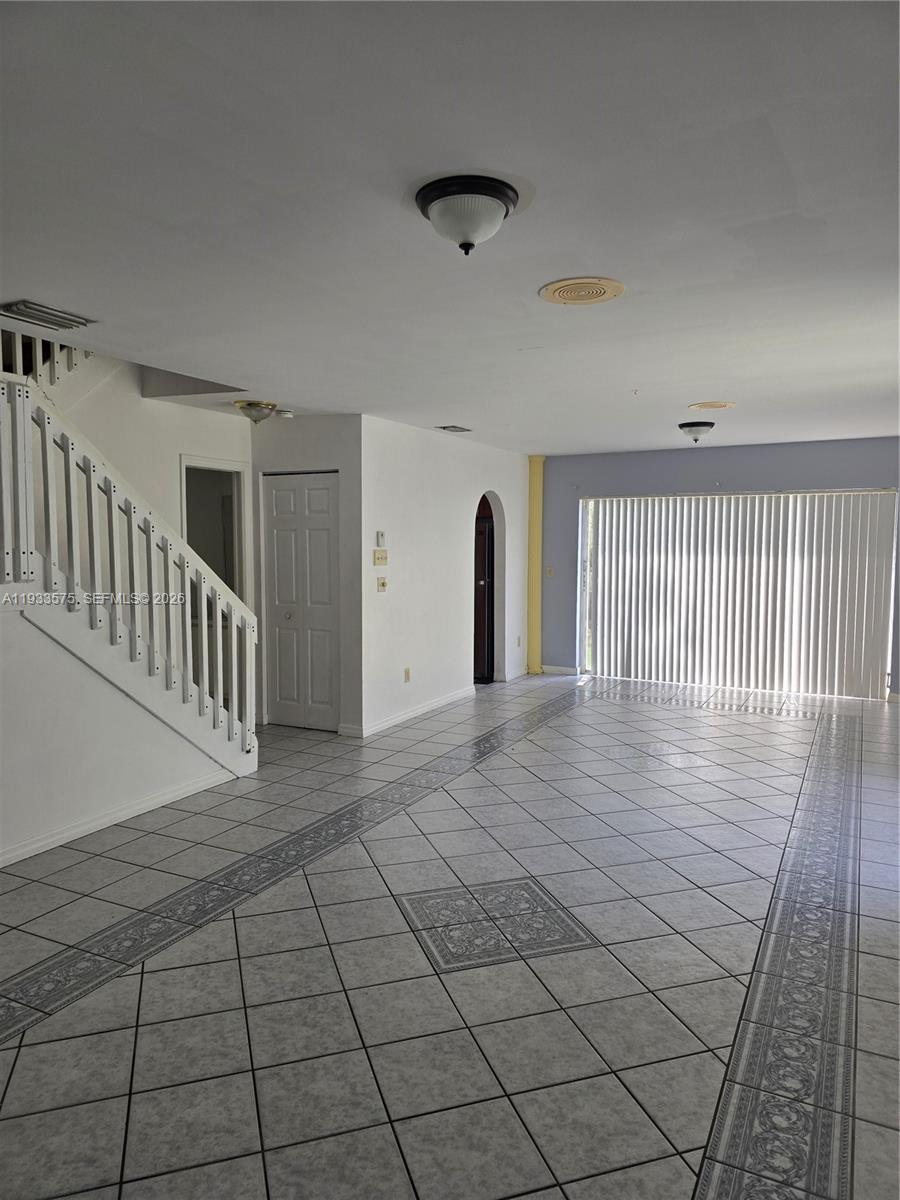 12687 Southwest 146th Street Miami, FL 33186 - Photo 18 of 20 a view of an empty room with glass door