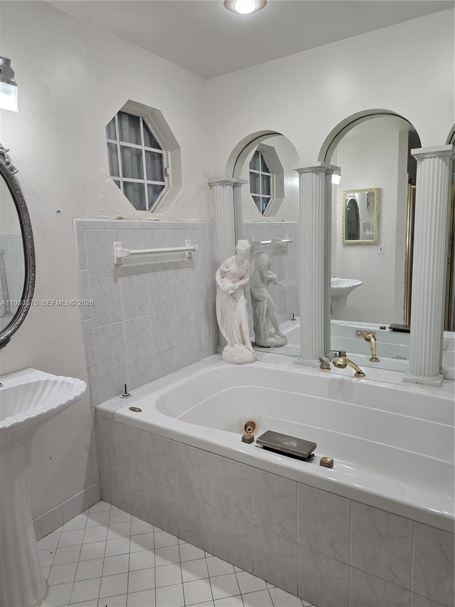 12687 Southwest 146th Street Miami, FL 33186 - Photo 7 of 20 a bathroom with a sink and a mirror