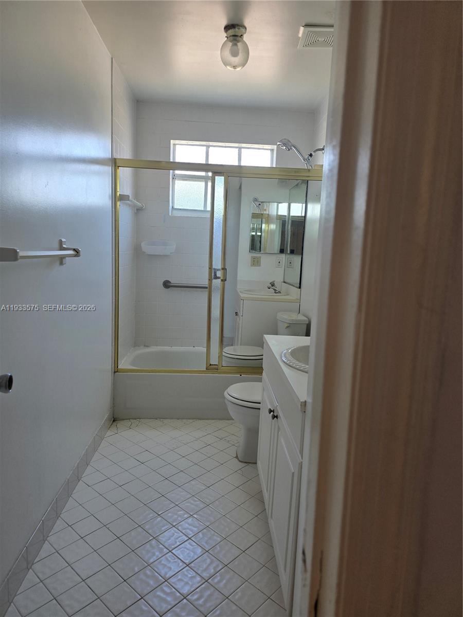 12687 Southwest 146th Street Miami, FL 33186 - Photo 9 of 20 a bathroom with a shower a sink a toilet and a shower