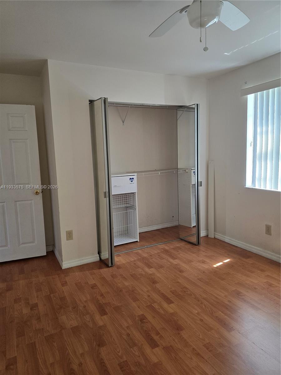 12687 Southwest 146th Street Miami, FL 33186 - Photo 10 of 20 an empty room with closet and windows