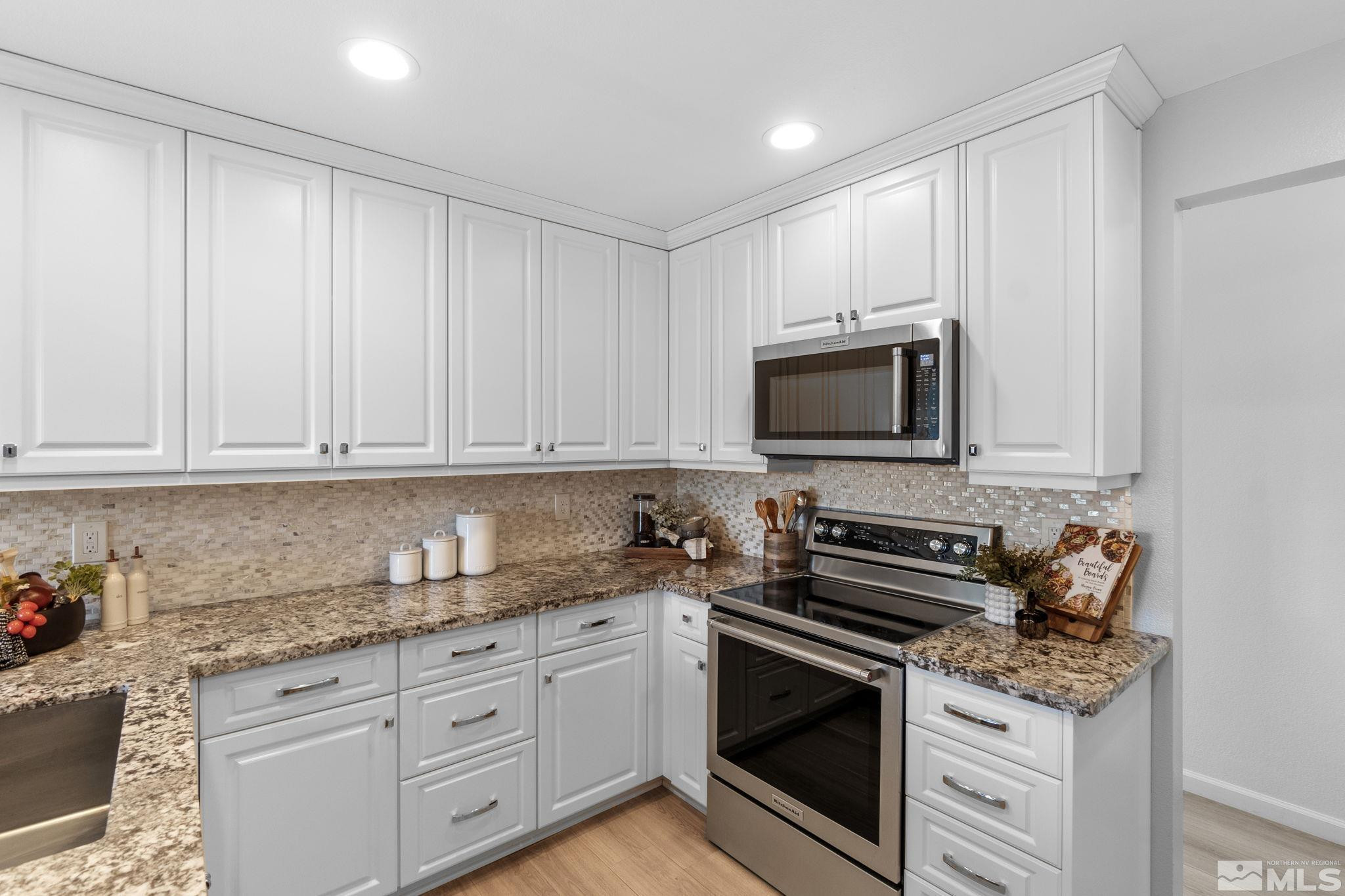 2332 Madera Court Reno, NV 89523 - Photo 15 of 36 a kitchen with granite countertop white cabinets and stainless steel appliances