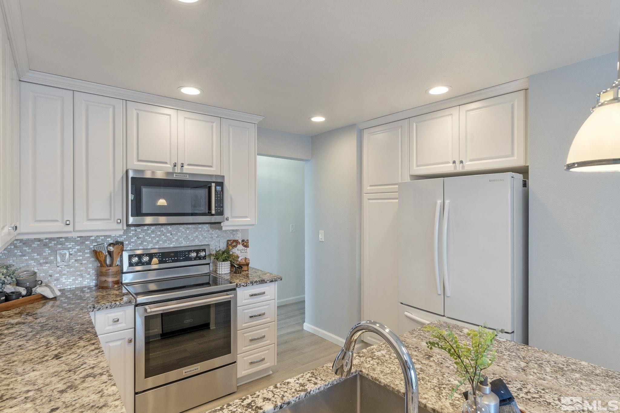 2332 Madera Court Reno, NV 89523 - Photo 16 of 36 a kitchen with stainless steel appliances granite countertop a stove a sink and a refrigerator
