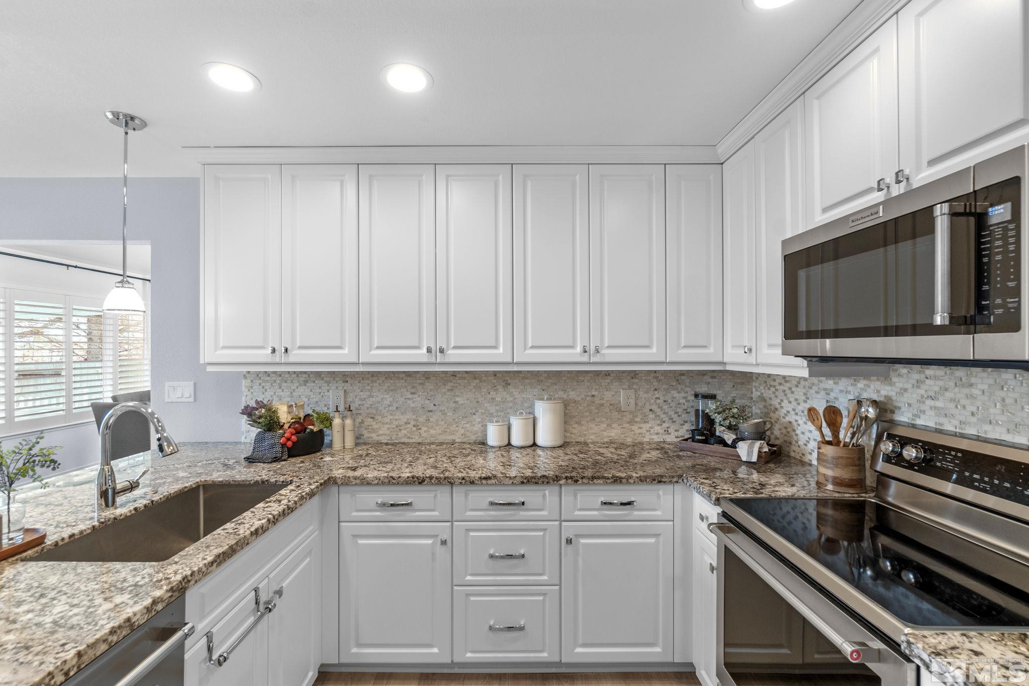 2332 Madera Court Reno, NV 89523 - Photo 17 of 36 a kitchen with granite countertop a sink stainless steel appliances and cabinets