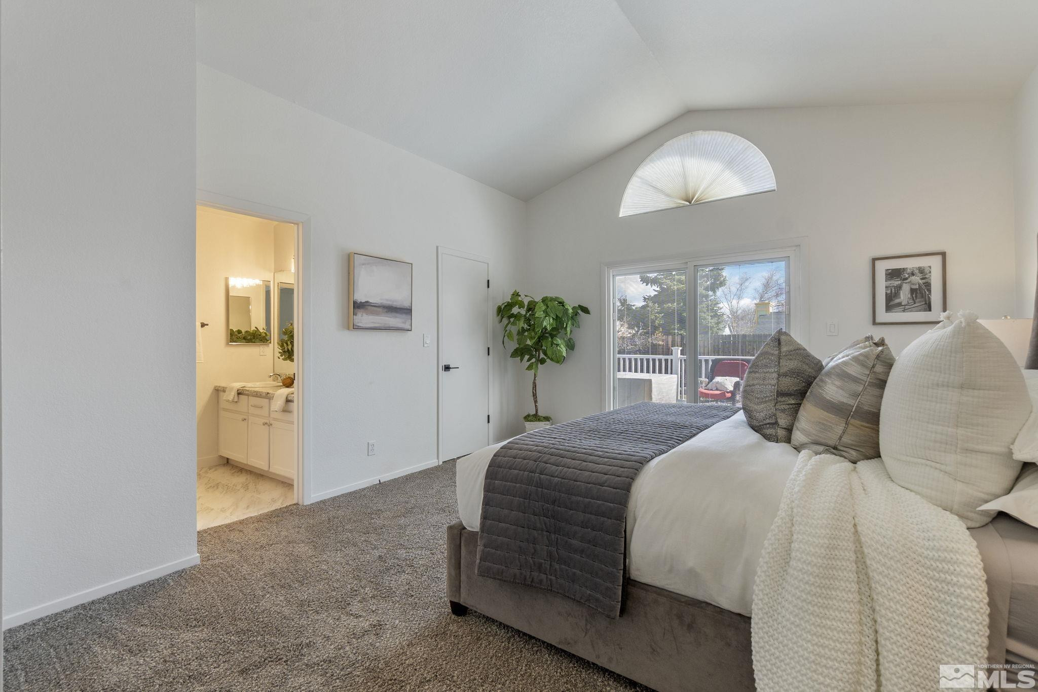 2332 Madera Court Reno, NV 89523 - Photo 23 of 36 a bedroom with a bed and a chandelier
