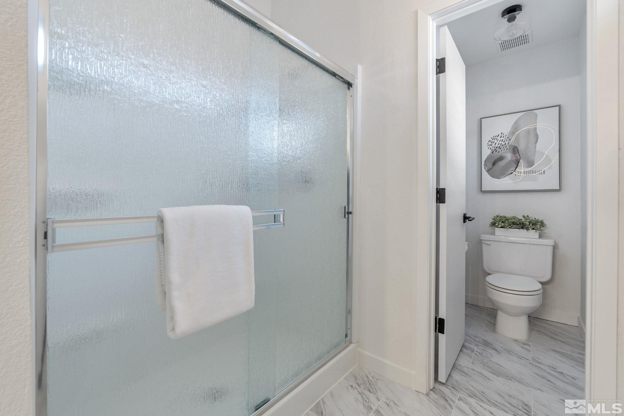 2332 Madera Court Reno, NV 89523 - Photo 24 of 36 a white toilet sitting next to a bathroom sink