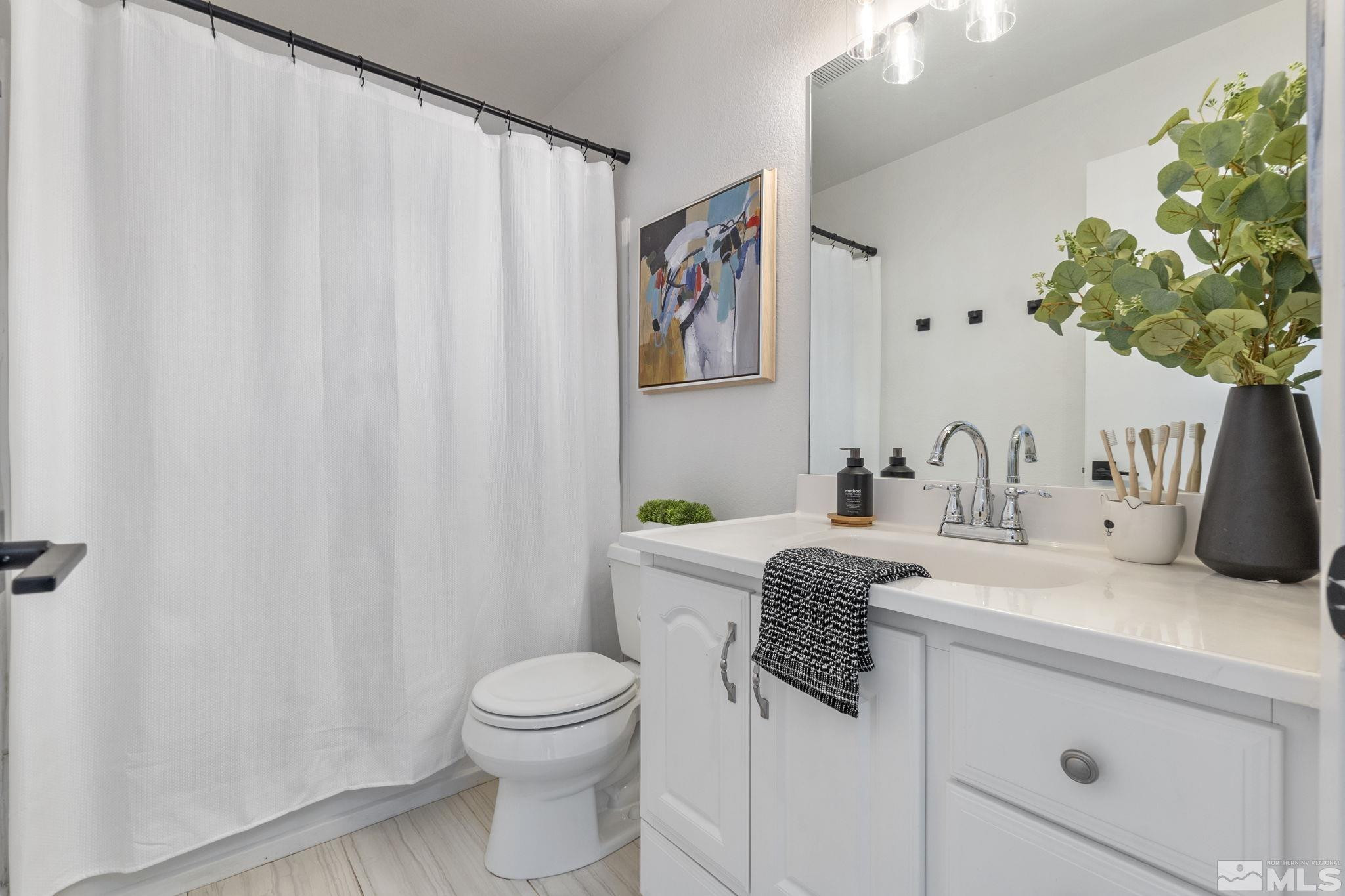 2332 Madera Court Reno, NV 89523 - Photo 29 of 36 a bathroom with a granite countertop sink a toilet and a mirror