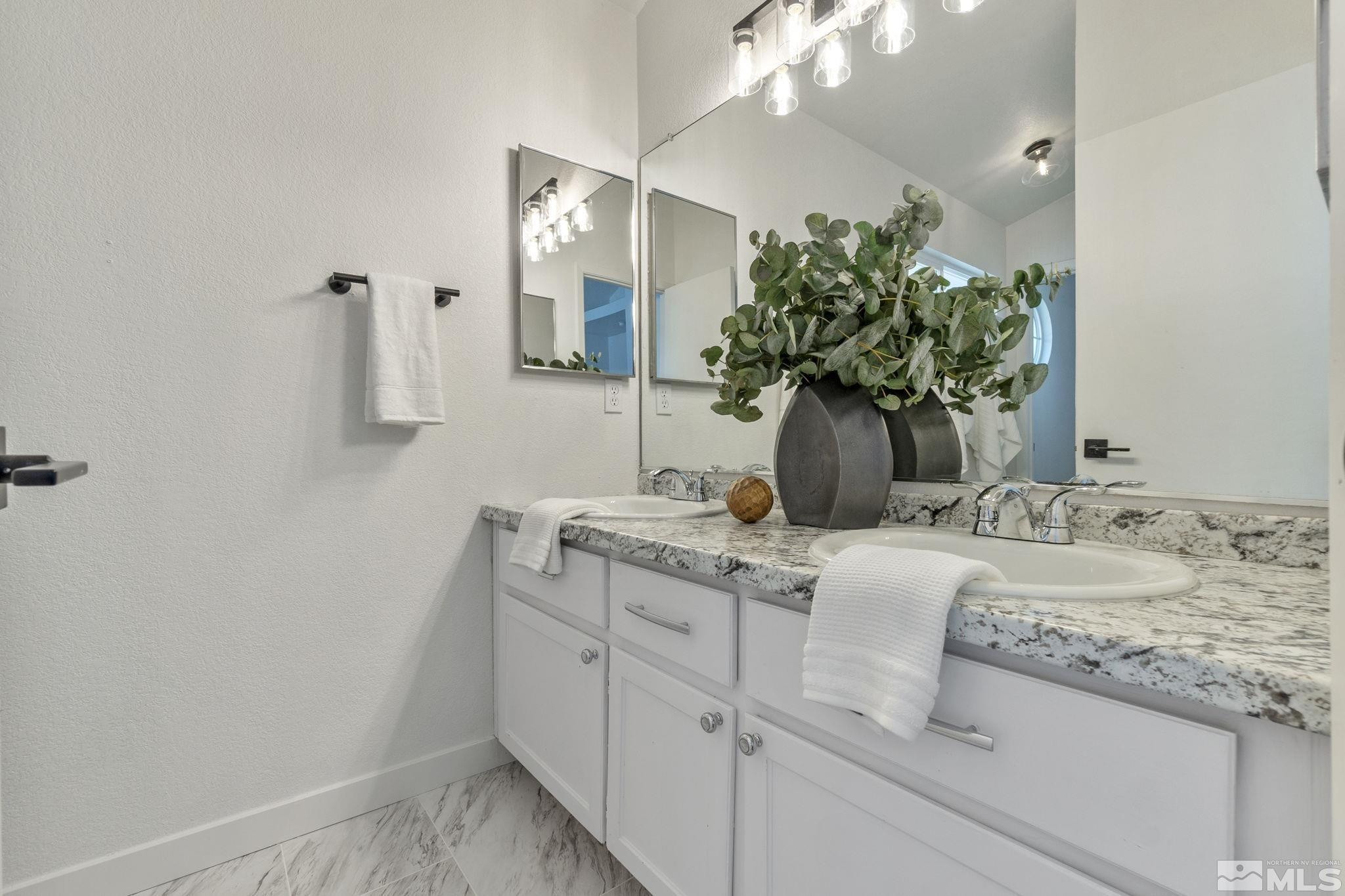 2332 Madera Court Reno, NV 89523 - Photo 30 of 36 a bathroom with a granite countertop sink a mirror and vanity