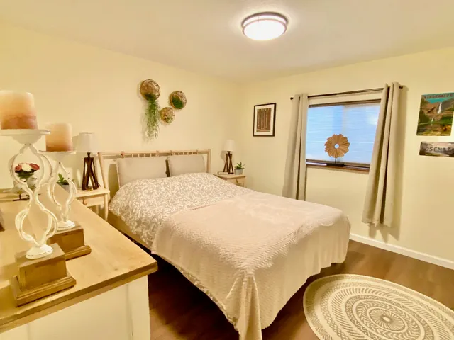 a bedroom with a bed and painting on the wall