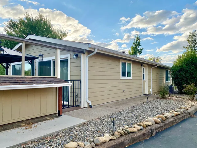 a backyard of a house with large trees