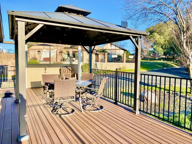a view of balcony with chairs and wooden floor