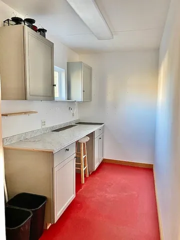 a kitchen with a sink stove and cabinets