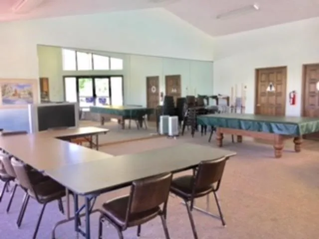 a view of a dining room with furniture and window